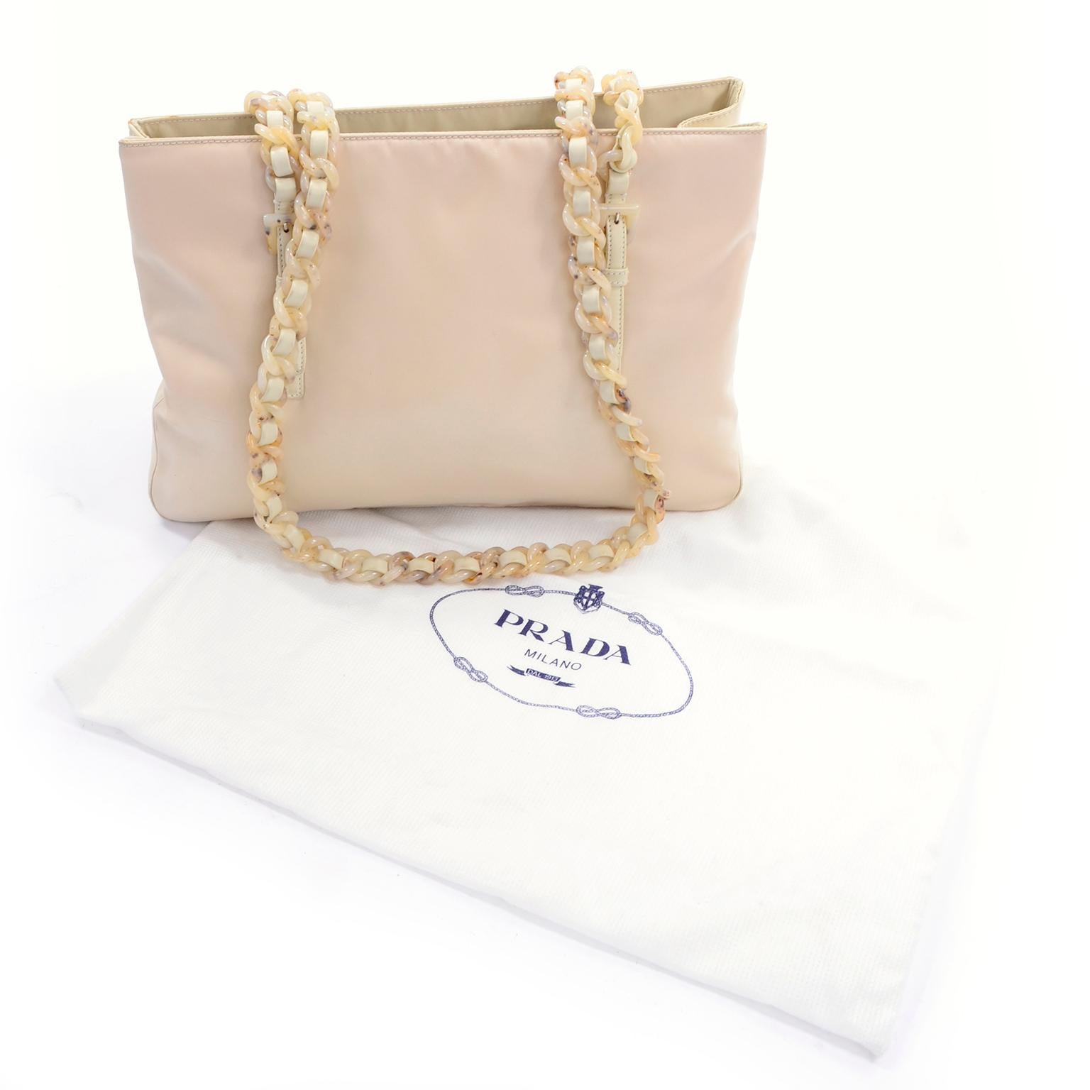 This is a cream / Blonde nylon Prada bag with faux cream tortoise chain link handles and two toned sides.  The bag was made in Italy and comes with its original dust bag.
HANDLE DROP: 15