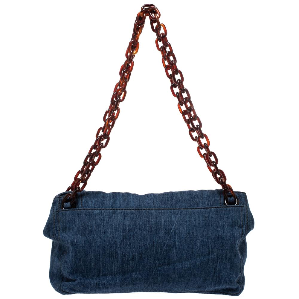 From the house of Prada, this bag is an outstanding fusion of brilliance and style. It is beautifully crafted from denim and enhanced with croc-embossed leather trims. The front flap opens to a leather lined interior and the bag features dual chain