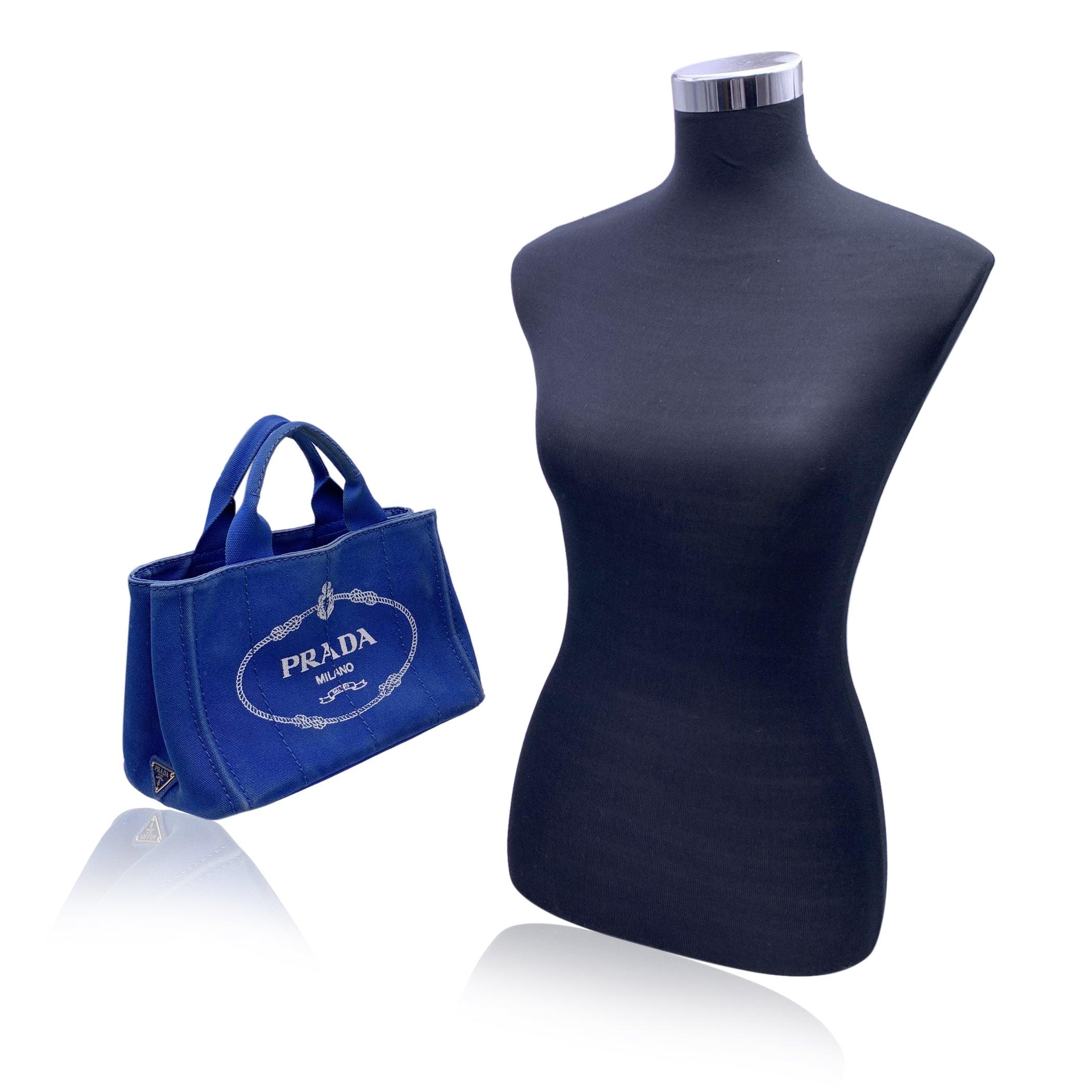 Introducing the Prada Canapa Small Tote Bag, a chic and versatile piece that embodies both casual elegance and iconic design. Crafted from durable blue hemp canvas, this tote bag is perfect for those who appreciate understated luxury with a