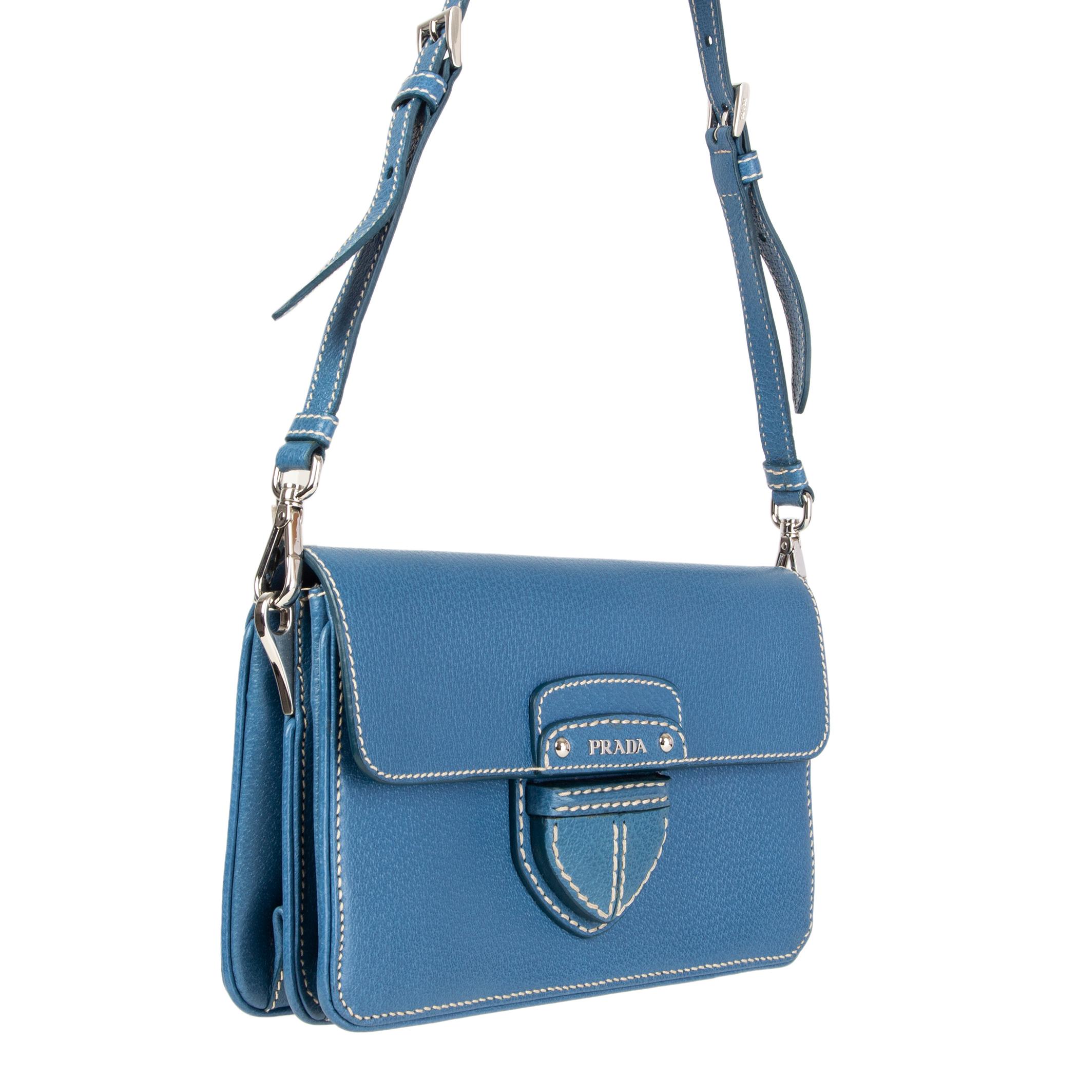 Prada crossbody bag in blue Cinghiale (pigskin) leather with contrasting white stitching. Detachable shoulder strap - can be carried as a clutch as well. Closes with a magnetic-snap on the front. Inside is divided into two compartements. Lined in