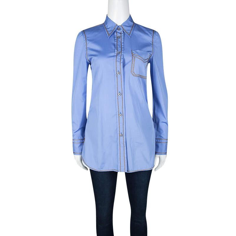 Give your off duty looks a modern twist with this chic Prada shirt. Cut from a blue cotton fabric this shirt comes with a button front and detailed with contrast embroidery detailing. It features full sleeves with buttoned cuffs and a classic