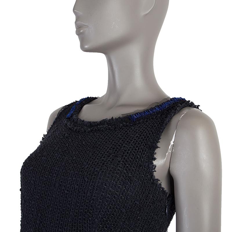 Prada box-pleat knit dress in midnight blue cotton (45%), wool (33%), linen (1%) and other fibre (3%) with beaded neckline and bow on the back neck. Opens with zipper on the side and ties with adjustable belt around the waist. Lined in midnight blue
