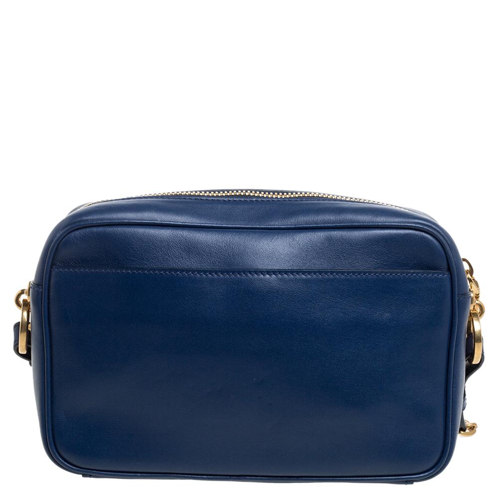 A beautiful and stunning piece from Prada, this camera bag will easily pair with your casual chic and glamorous looks with equal ease. Crafted in blue leather, this bag also features crystal embellishments and the brand label on the front. A