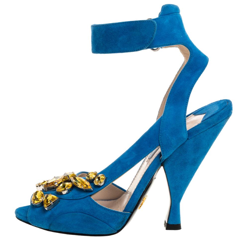 These Prada sandals are all about glitz and glam. Fashioned in blue suede, these sandals feature cross-over frontal straps that are beautifully decorated with crystal embellishment. It is secured with ankle strap closure. We think this glamorous