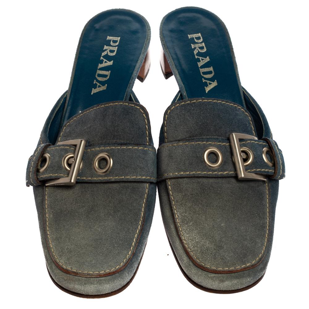 Walk in these Prada mules for maximum style and comfort. Crafted from denim and lined with leather on the insoles, this pair comes wonderfully shaped into square toes with buckles and lifted on block heels. You can team them up with your casual