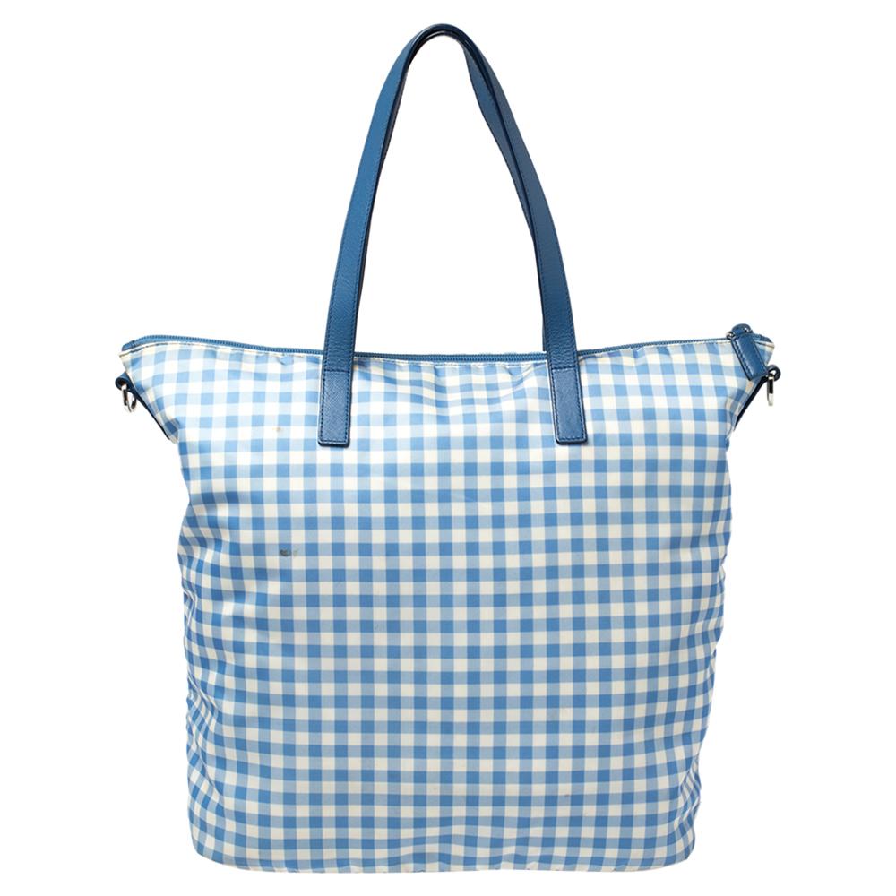 Prada brings to you this pretty bag. Complemented with a classic blue gingham print all over, this tote is all you need to flaunt your style this season. it has been crafted from nylon and comes with dual handles, a logo in the front, silver-tone