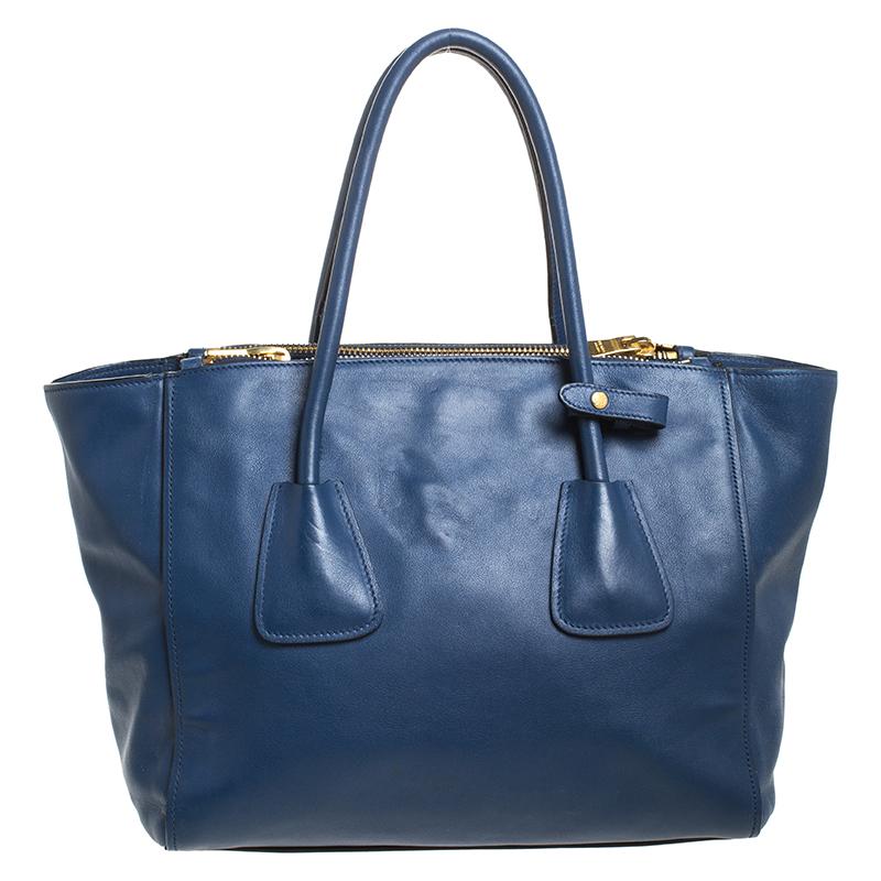 Add some effortless style and luxury to your everyday looks with this stunning Prada Twin tote. Crafted in Italy, it is made of blue Glace leather and has a lovely silhouette. It has a zip closure that leads to a nylon-lined interior with a zip