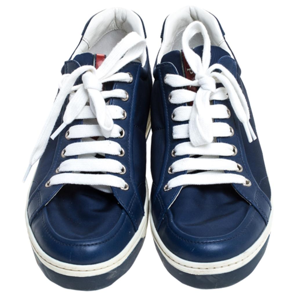 Fall in love with casual wear every time you step out in these sneakers from Prada. They've been crafted from blue leather and fabric and are styled with laces on the vamps. The sneakers are filled with comfort and effortless style.

Includes: