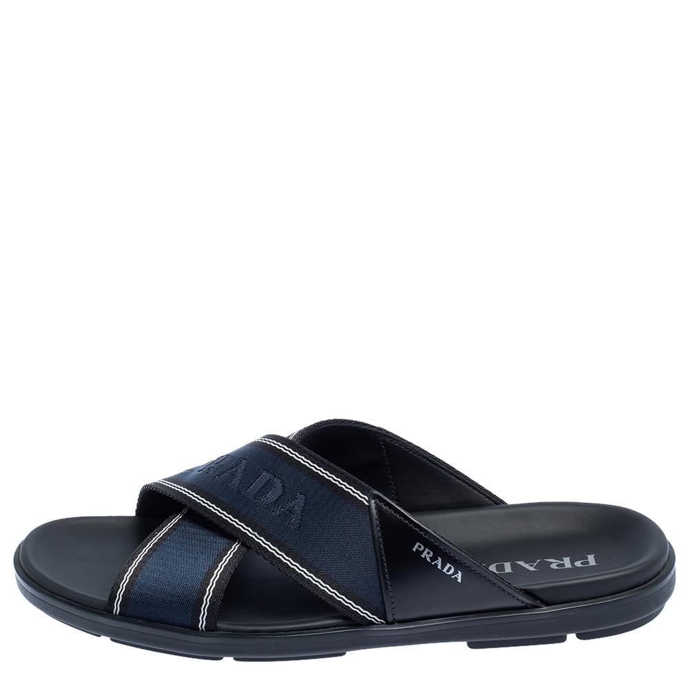 These blue slides by Prada are stylish and super comfortable. They have been crafted from leather and nylon and designed with open toes and logo-detailed crisscross vamp straps. Easy to slip on, they come with leather-lined insoles and durable