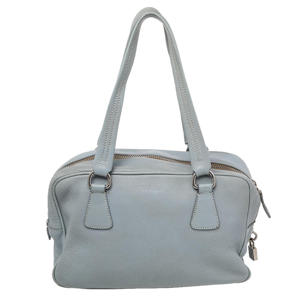 The Prada Bauletto bag is spacious and stylish. It will give you all the space you need. It features a leather exterior, dual-leather handles, the clochette on the front, and silver-tone hardware. The fabric-lined interior has one zip pocket.