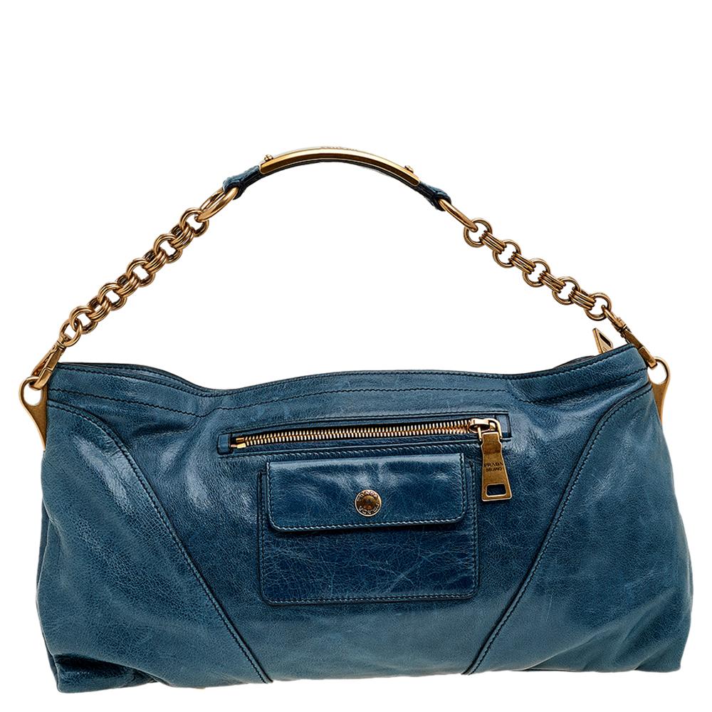 This Prada handbag is an example of the brand's fine designs that are skillfully crafted to project a classic charm. The shoulder bag is made of leather and added with gold-tone hardware, a chain handle, and a leather-lined interior.

Includes: