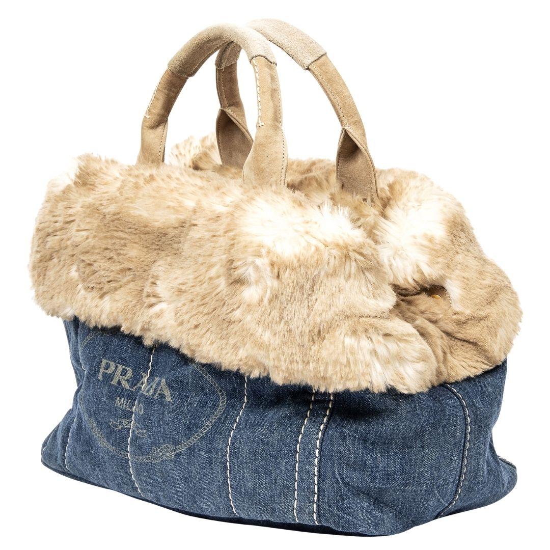 A blue Canapa denim canvas tote with gold hardware, magnetic snap closure, and a logo jacquard interior, featuring one zippered pocket and two slip pockets for ample storage.

SPECIFICS
Length: 16.5
Width: 9.5
Height: 9.1
Strap drop: