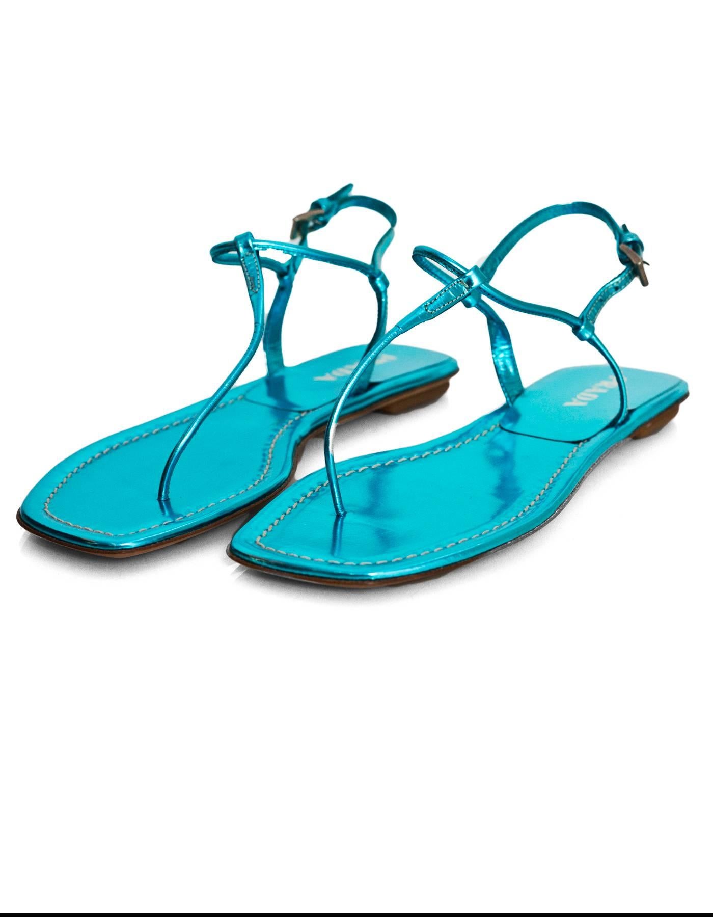 Prada Blue Metallic T-Strap Sandals Sz 35.5 NEW

Made In: Italy
Color: Blue
Materials: Leather
Closure/Opening: Buckle closure at ankle
Sole Stamp: Prada vero cuoio 35.5 made in italy
Retail Price: $550 + tax
Overall Condition: Excellent pre-owned