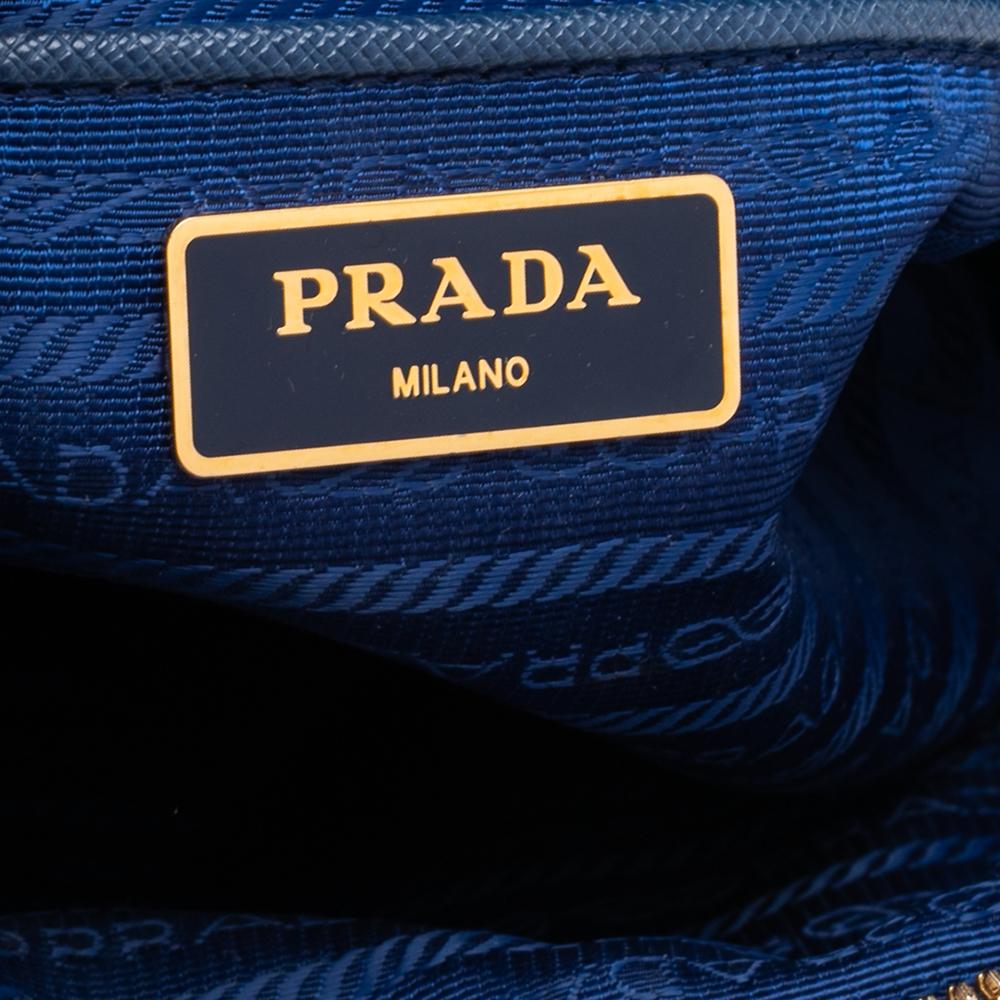 This Dome satchel from Prada is a great buy. It has been tailored creatively to offer functionality with never-ending style. It is made using blue nylon and leather on the exterior with a dainty gold-toned logo motif perched n the front. It is held