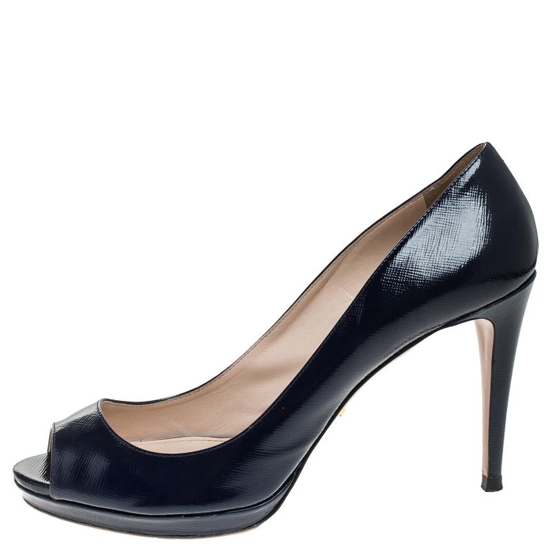 This pair of pumps by Prada is a timeless classic. Step out in style while flaunting these blue patent leather shoes, ideal for all occasions. They feature peep toes, platforms and 10 cm heels.

Includes: Original Dustbag

