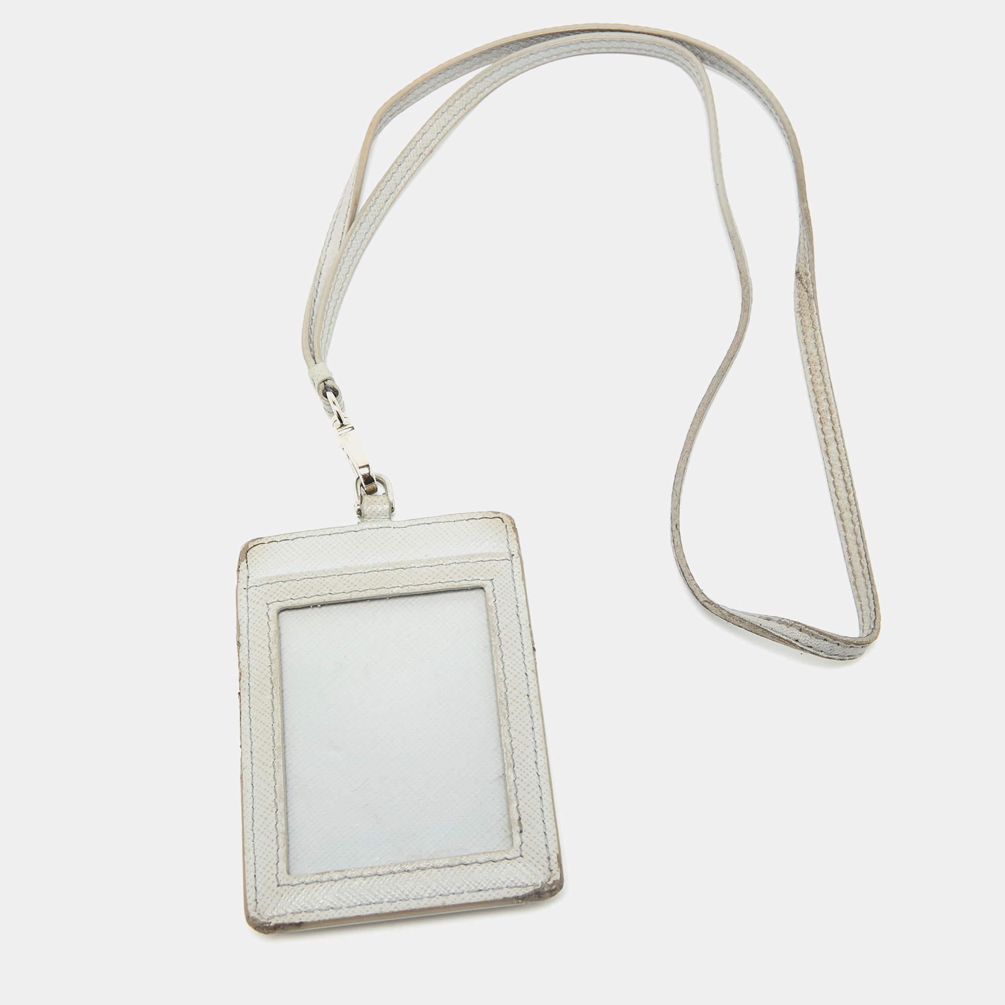 Crafted from luxurious Saffiano leather the Prada Badge Holder epitomizes elegance and practicality. Its sleek design boasts a clear ID window and multiple card slots perfect for organizing essentials with finesse. A Prada logo adds a touch of