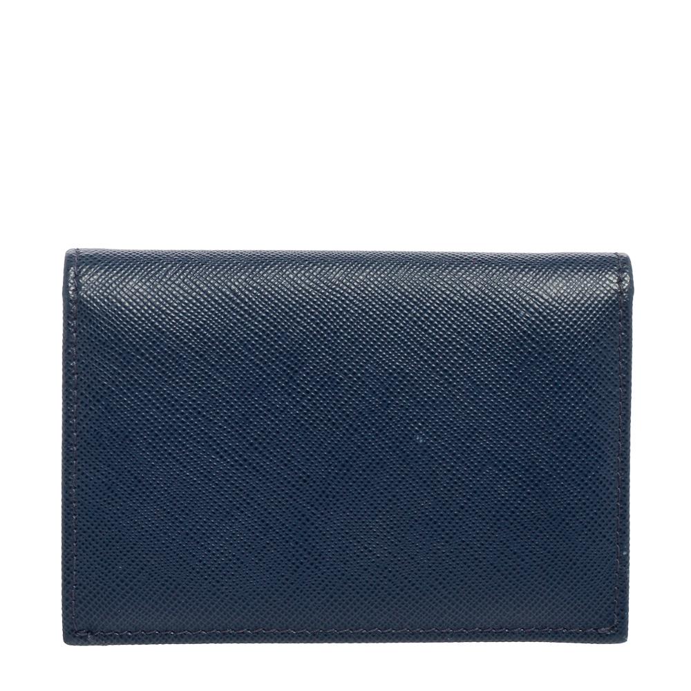 Crafted from blue Saffiano leather, this Prada card case opens to reveal a lined interior to carry your cards neatly. This designer card case is finished with the brand name on the flap.

Includes: Original Box, Authenticity Card