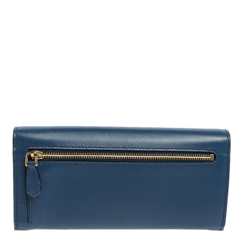 Detailed with Prada's iconic logo at the front, this leather continental wallet has an instantly recognizable charm of luxury. The blue wallet features a flap design and an interior equipped to neatly hold your cards, coins, and bills.

Includes: