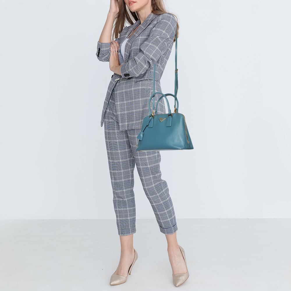 This stunning Promenade satchel is high in appeal and style. Dazzling in a classy blue shade, the bag is crafted from leather and features two rolled handles. The zip closure leads way to a fabric interior with enough space for your essentials and