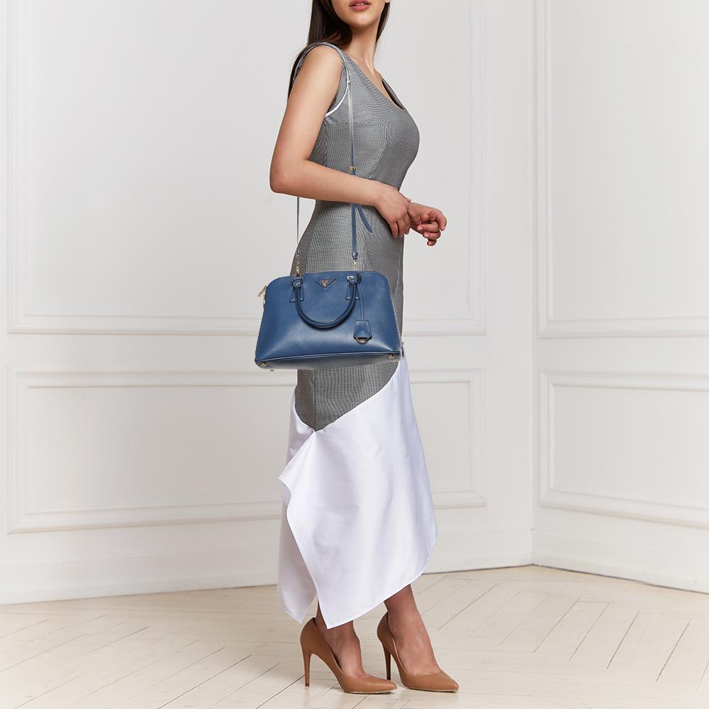 This stunning Promenade tote is high on appeal and style. Dazzling in a classy blue shade, the bag is crafted from Saffiano Lux leather and features two rolled handles. The zip closure leads way to a nylon interior with enough space for your