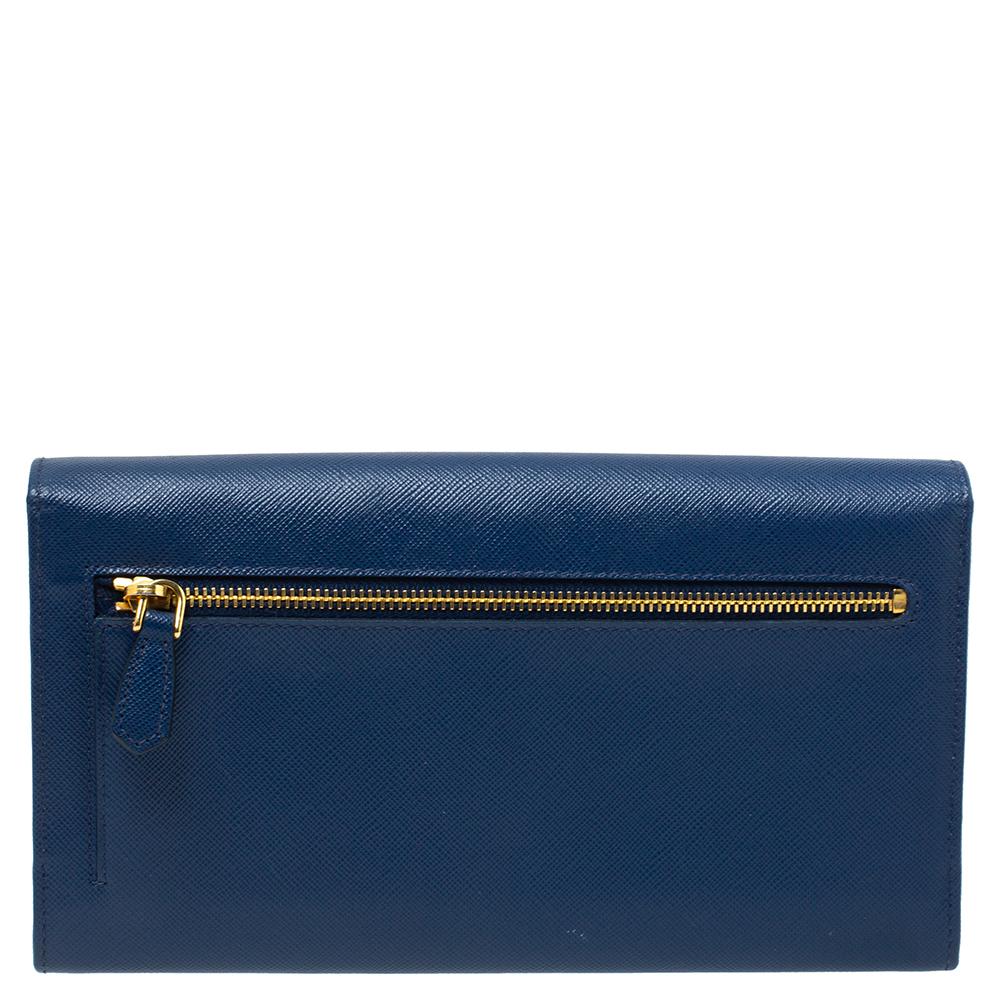This gorgeous wallet from Prada is classy and chic and will last you forever. Made from Saffiano Lux in a luxurious blue hue, the front flap's silhouette is adorned with a gold-tone metal bar. The easy-to-organize interior is lined with nylon &