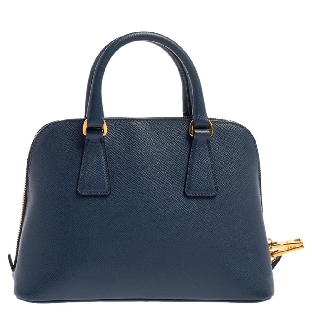 This stunning Promenade tote is high on appeal and style. Dazzling in a classy blue shade, the bag is crafted from Saffiano Lux leather and features two rolled handles. The zip closure leads way to a nylon interior with enough space for your