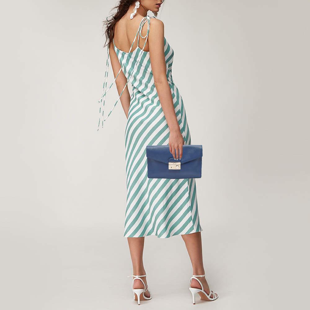 This Prada blue clutch for women has the kind of design that ensures high appeal  whether held in your hand or tucked under your arm. It is a meticulously crafted piece bound to last a long time.