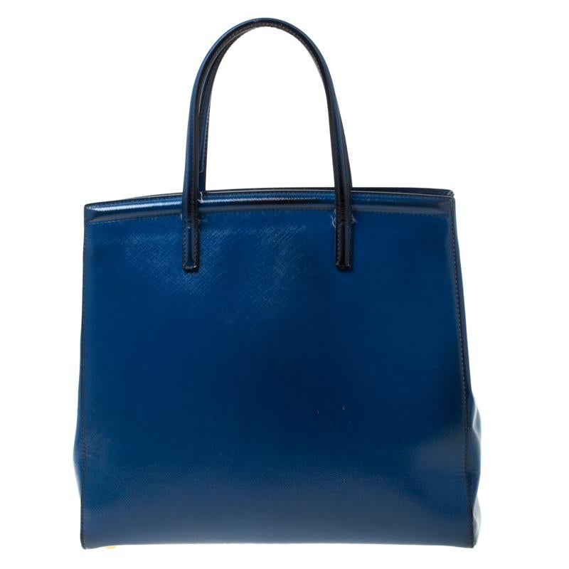 Masterfully created, this Prada tote is a style icon. Designed in a patent leather body, it exudes style and class in equal measures. This delightful blue piece is held by two top handles and equipped with a spacious fabric interior.

Includes: