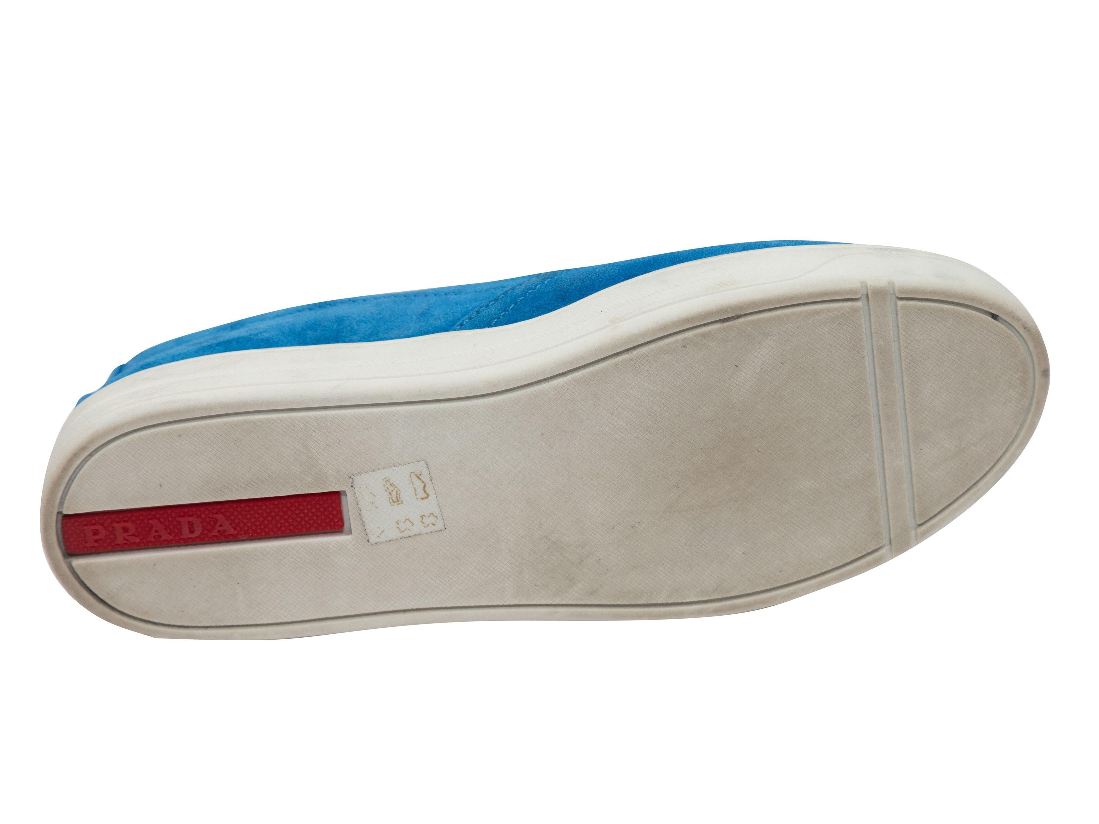 Product Details: Blue suede low-top slip-on sneakers by Prada. Elasticized gores at sides. Rubber soles. 1