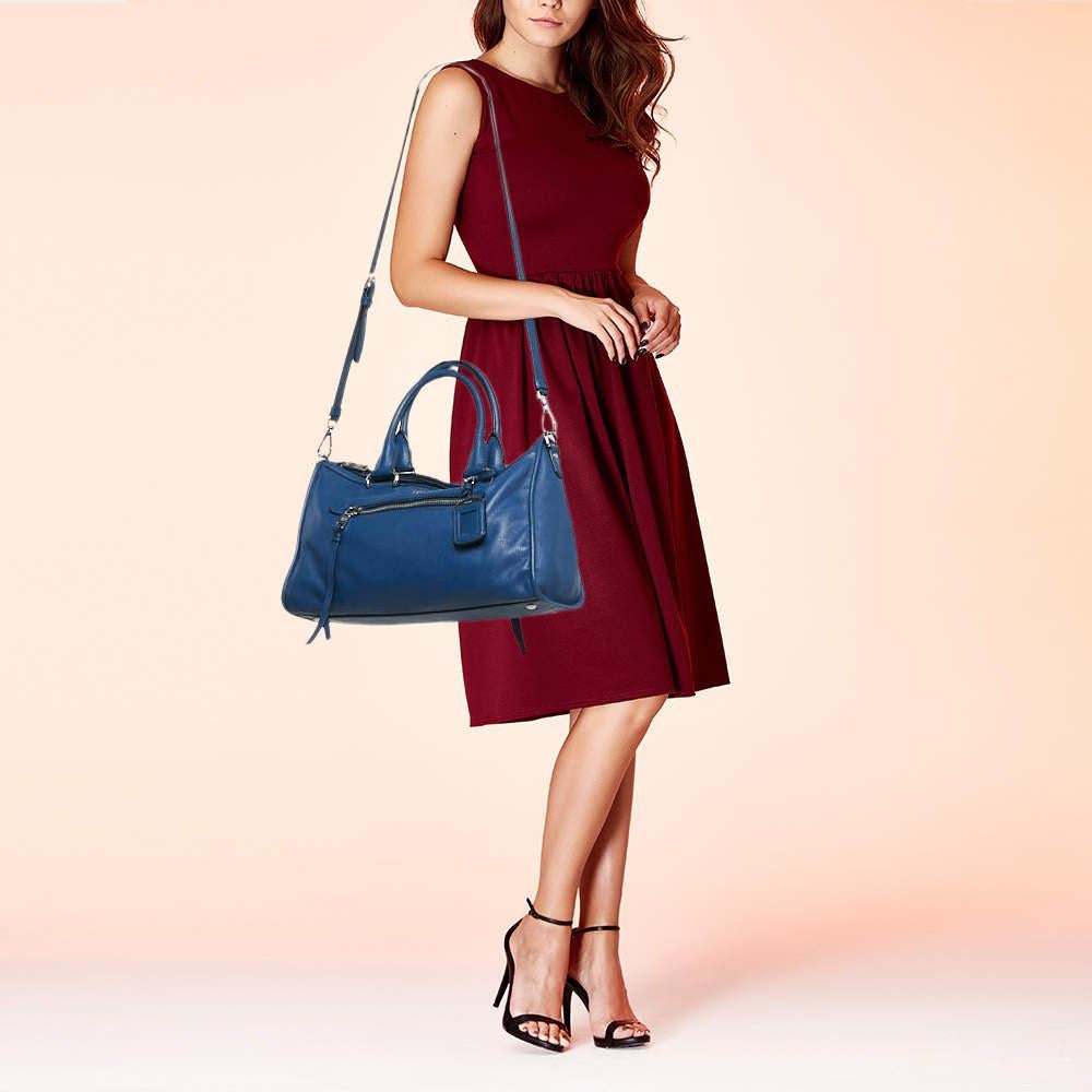 Marked by flawless craftsmanship and enduring appeal this Prada blue satchel is bound to be a versatile and durable accessory. It has a spacious size.