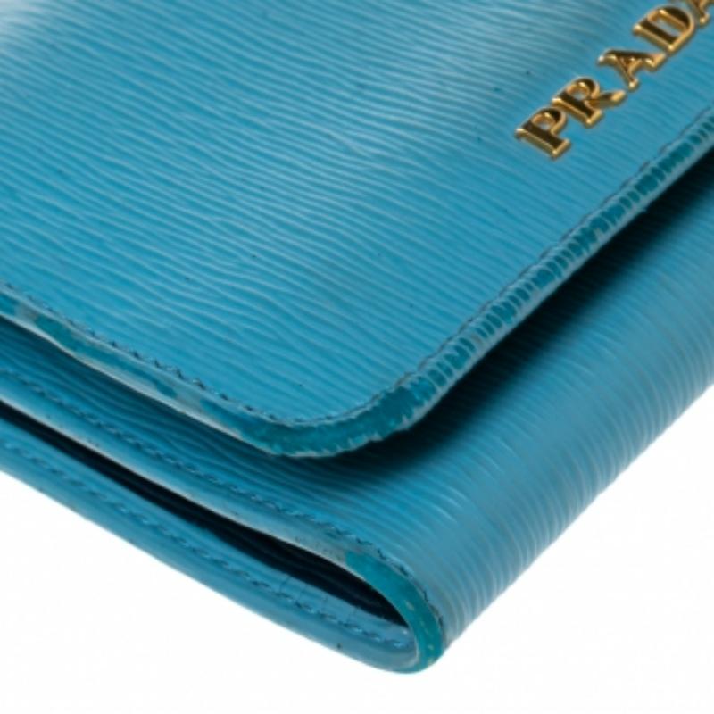 Realizzato in pelle Saffiano Lux, questo portafoglio Prada presenta la firma del marchio sul davanti. Il bottone a pressione si apre su un interno a tre ante con uno scomparto per le banconote, slot per le carte e una tasca per le monete.
