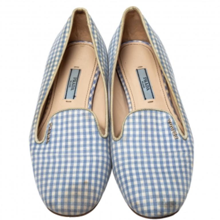 These blue and white loafers by Prada are stylish and comfy. Made from check canvas, they feature round toes and gold-tone brand logo detailing on the vamps. The insoles are leather-lined for comfort and overall, the pair exudes a fashionable vibe.