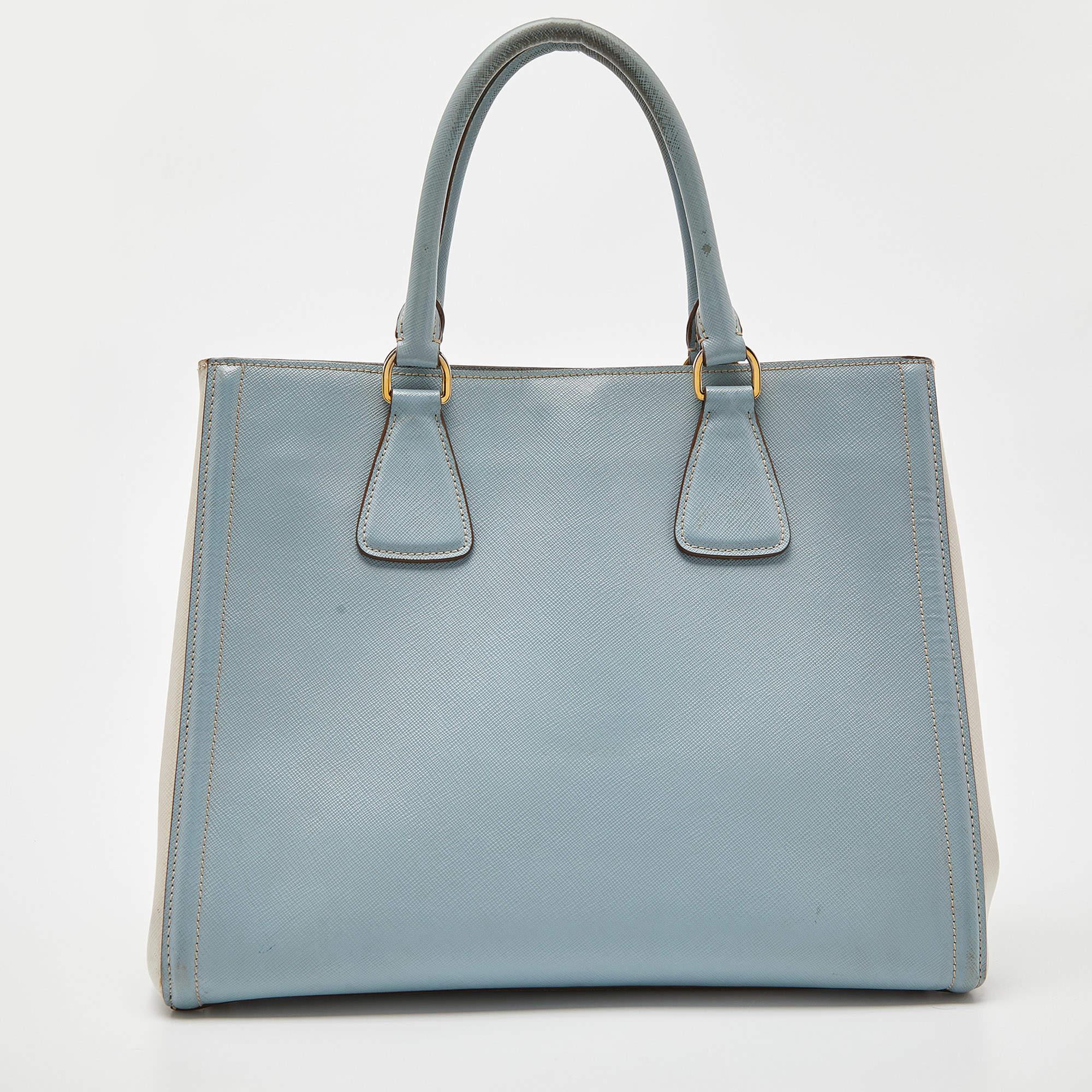 Bringing a mix of timeless fashion and fine craftsmanship is this tote from Prada. The bag comes with a durable Saffiano Lux leather exterior, comfortable handles, shiny hardware, and a capacious interior. Fine elements complete the tote in a luxe