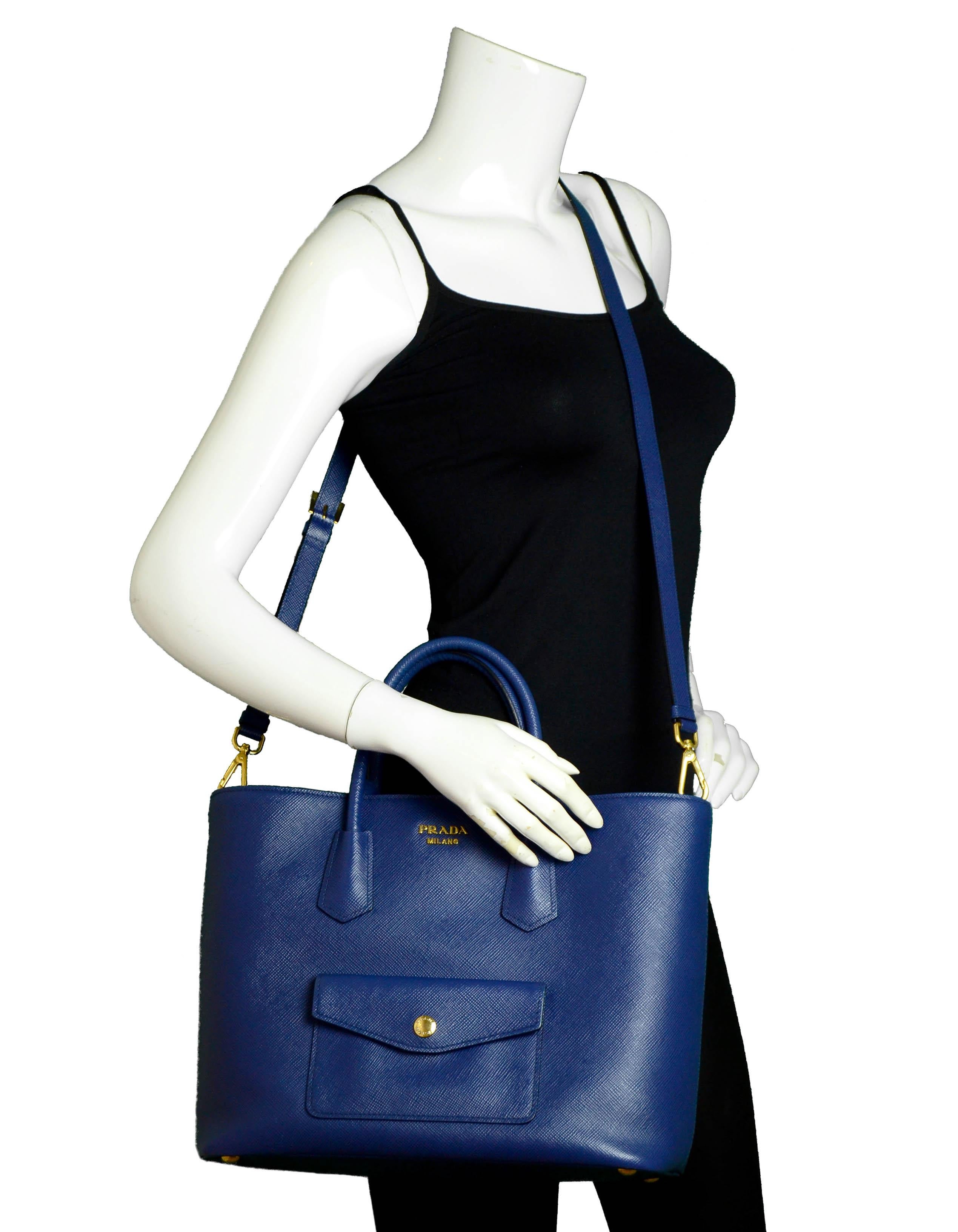 Prada Bluette Blue Saffiano Front Pocket Tote Bag w/ Detachable Strap

Made In: Italy
Year of Production:2014
Color: Bluette blue
Hardware: Goldtone
Materials: Saffiano leather
Lining: Smooth leather
Closure/Opening: Snap
Exterior Pockets: Flap