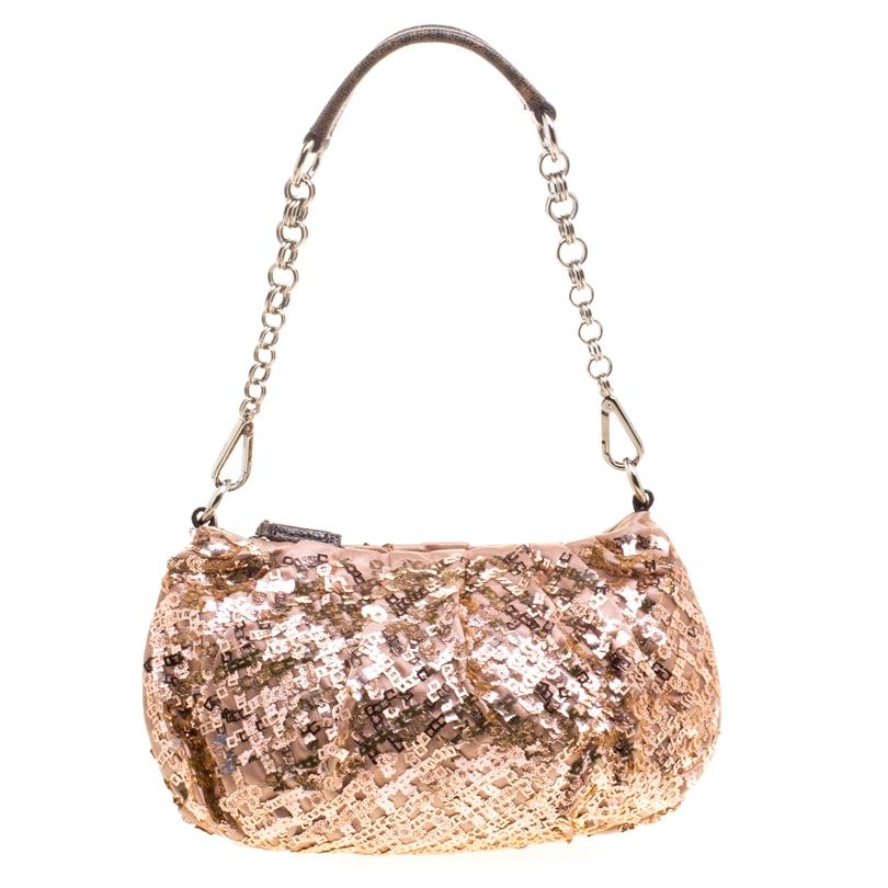 Get your bling on with this chic Prada bag. It features a satin body with pink and bronze sequin embellishment all over it. Secured with a top zipper closure, this bag comes with a chain top and a leather shoulder section. It is perfect for parties