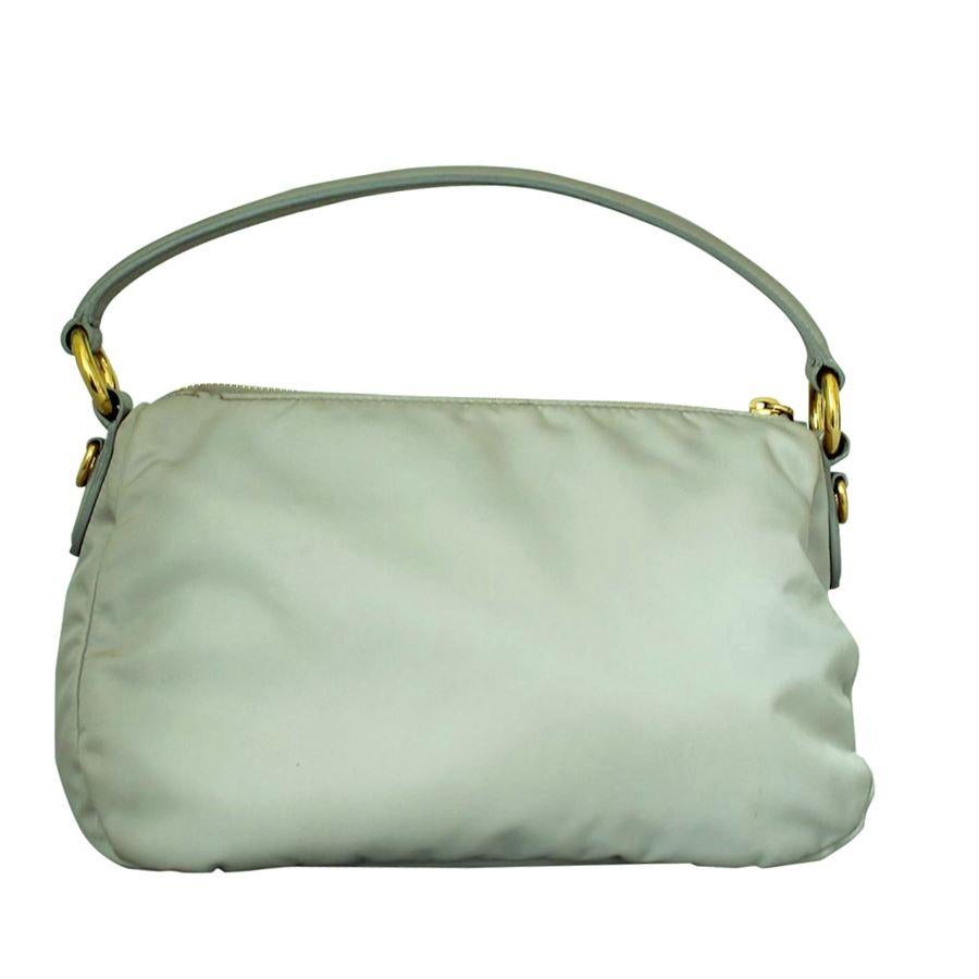 Beautiful Prada bag
Sailcloth 
Pearl grey color
Leather handle
Central bow
Zip closure
Internal zip pocket
Golden metal inserts
Cm 28 x 16 x 12 (11 x 6.2 x 4.72 inches)
Fast international shipping included in the price.