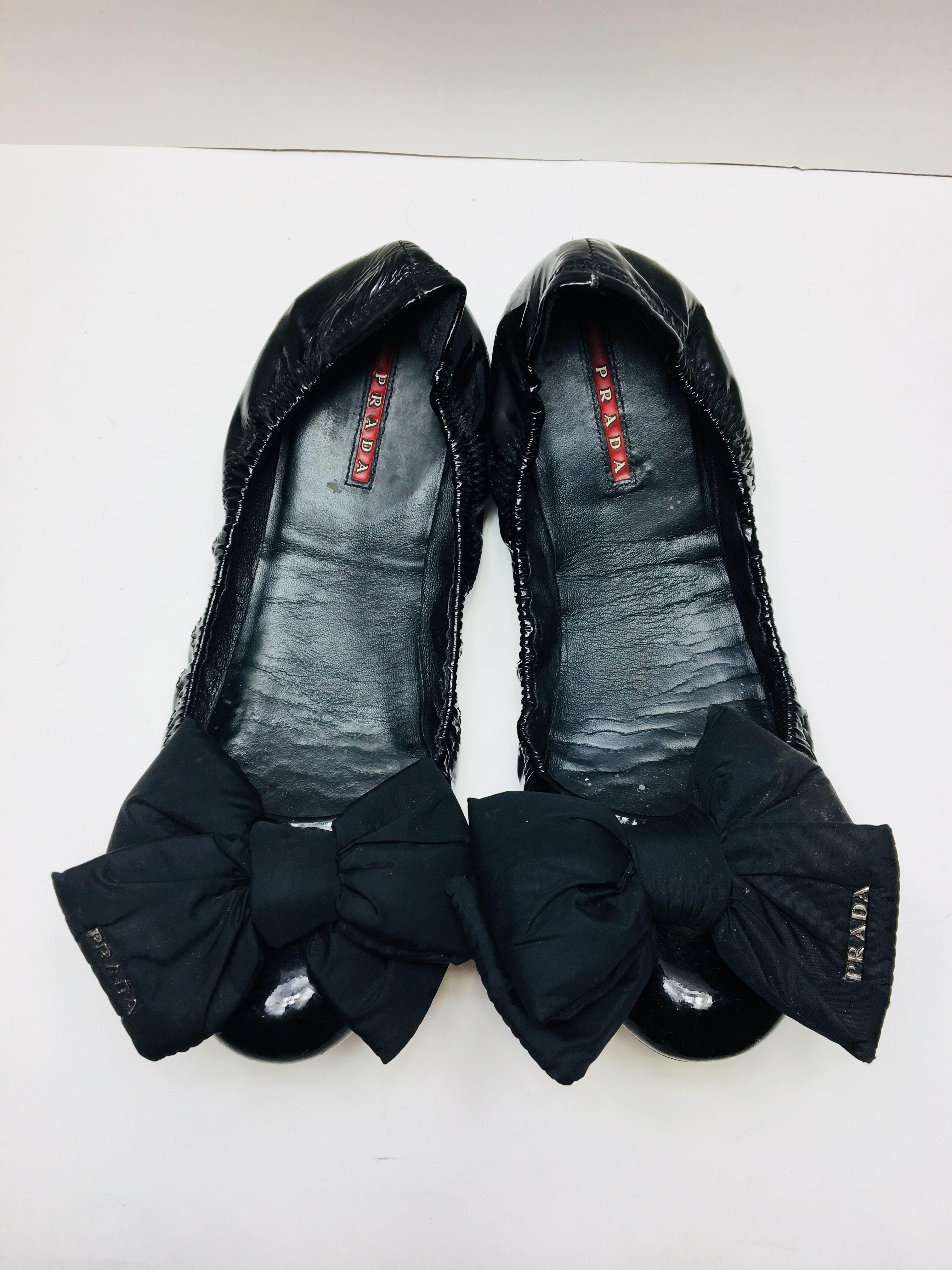 Prada Black Patent Leather Ballet Flat with Bowtie Front. 
Slightly Worn.
Size 39.5