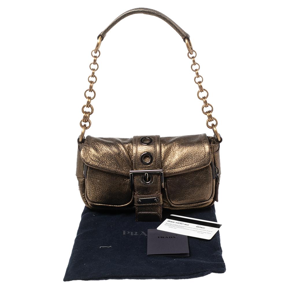 This stunning shoulder bag by Prada is stylish and perfect for day-outs or evenings even. Crafted from quality leather in a lovely shade of bronze, it is styled with front buckle detailing, a single handle, and a fabric-lined interior.

Includes: