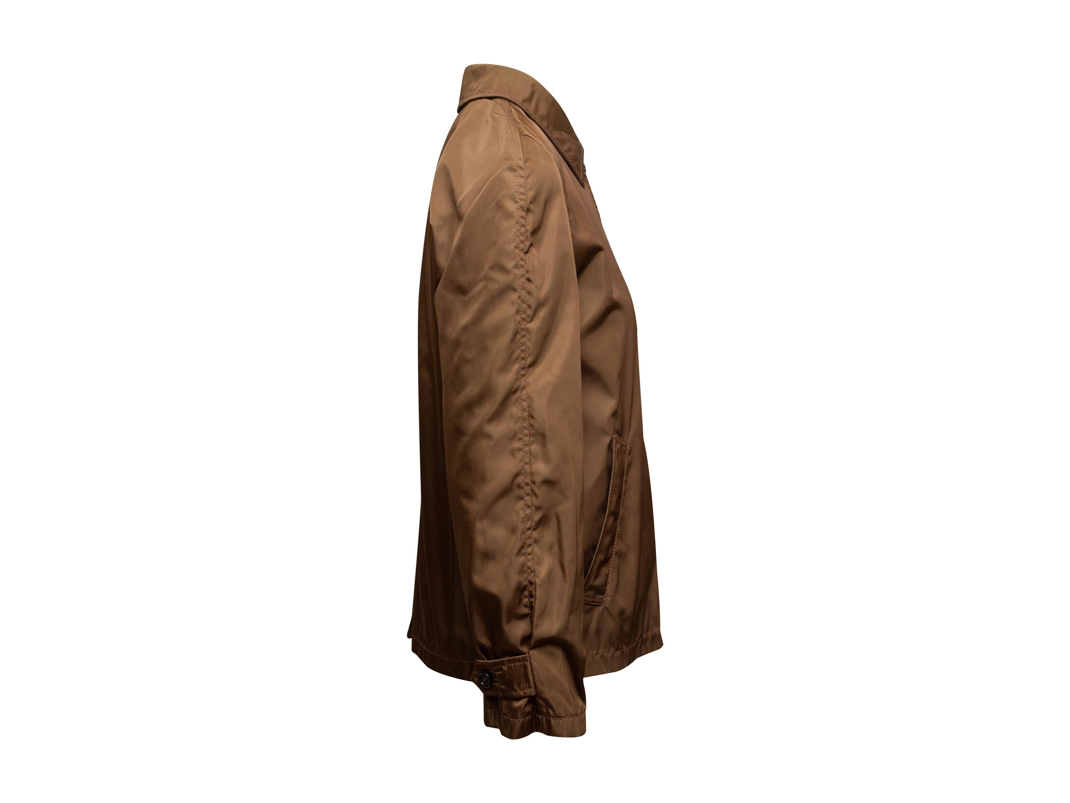 Product details: Vintage brown lightweight nylon jacket by Prada. Circa 1990s. Pointed collar. Dual hip pockets. Concealed closures at center front. 34