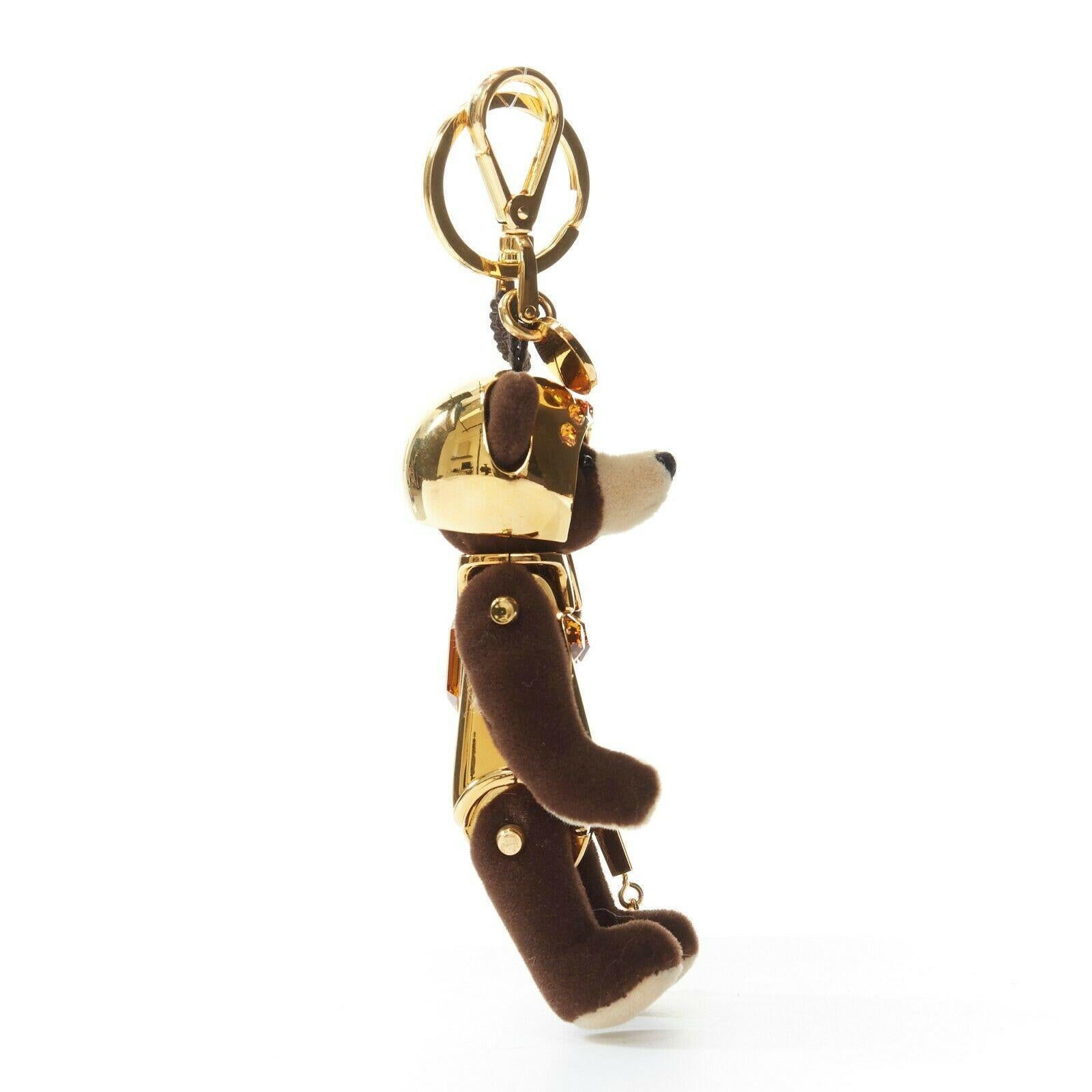 PRADA brown bear gold robot yellow crystal keyring keychain charm 
Reference: TGAS/A03378 
Brand: Prada 
Material: Metal 
Color: Gold 
Pattern: Solid 
Extra Detail: Brown bear wearing gold robot costume with yellow crystal embellishment. Keyring