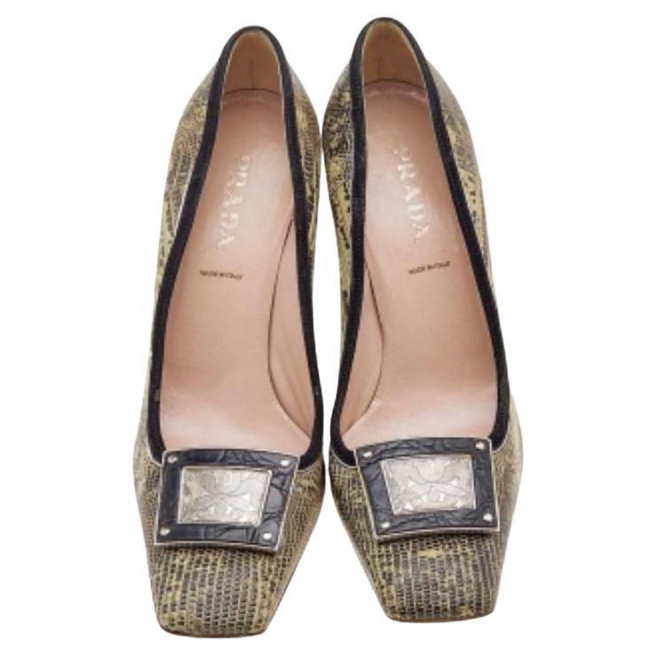 How classy are these pumps from the House of Prada! They are designed using brown-beige lizard leather and suede trims on the exterior. They showcase a silver-tone embellishment on the toes, 10 cm heels, and an easy slip-on feature. Look classy as