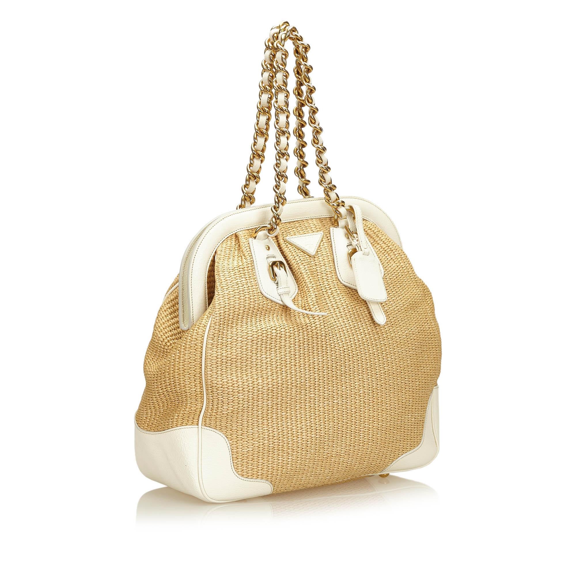 This shoulder bag features a straw body with leather trim, gold-tone chain handle, magnetic top closure, interior zip pocket, and an interior slip pocket. It carries as A condition rating.

Inclusions: 
Dust Bag
Authenticity