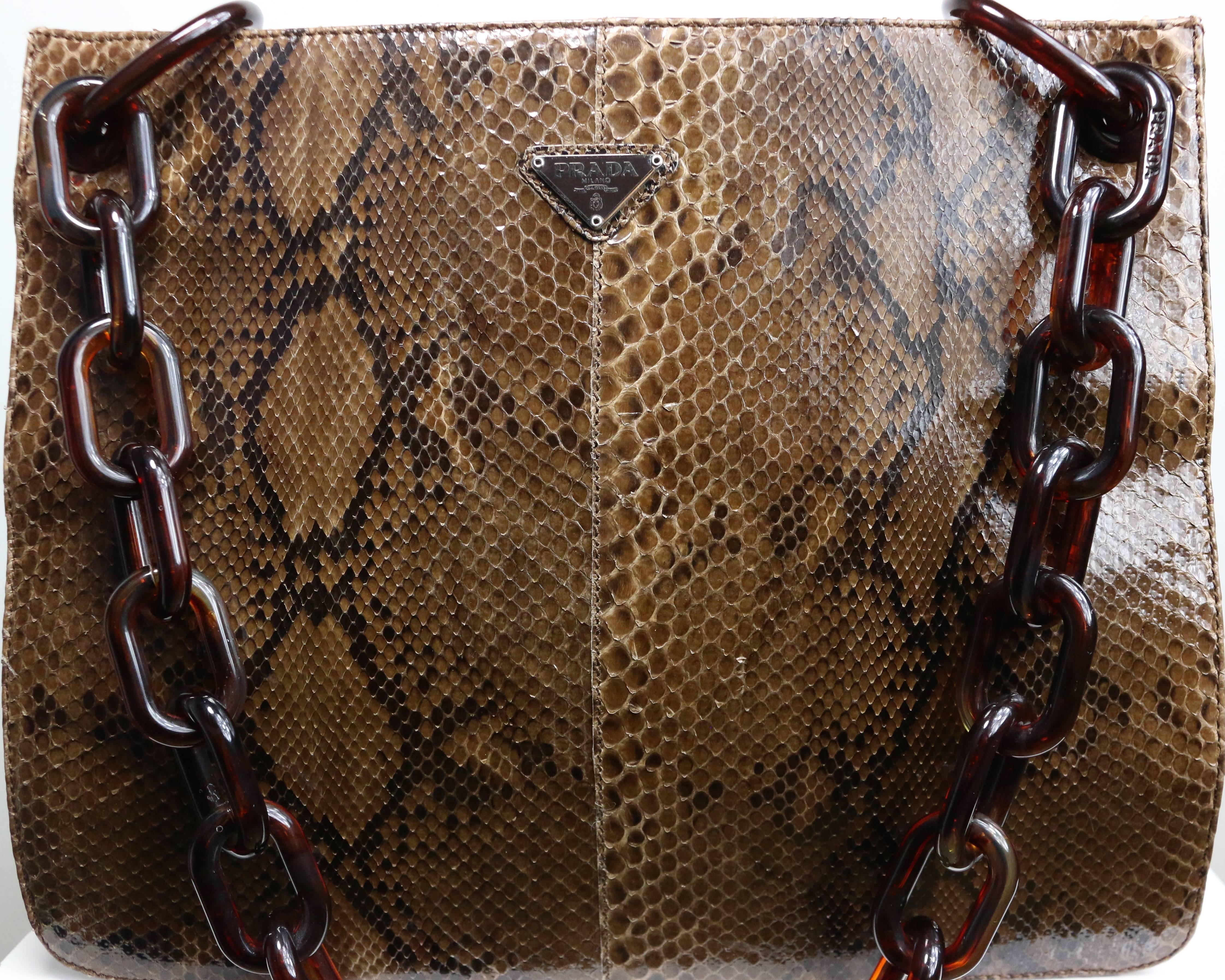- Vintage 90s Prada brown colour in python pattern and tortoise shoulder strap.

- Featuring brown/green kaahi nylon material on both sides. 

- Prada brown interior lining with an interior zip pocket. 

- Measurement: Length: 12 inches. Height: 10