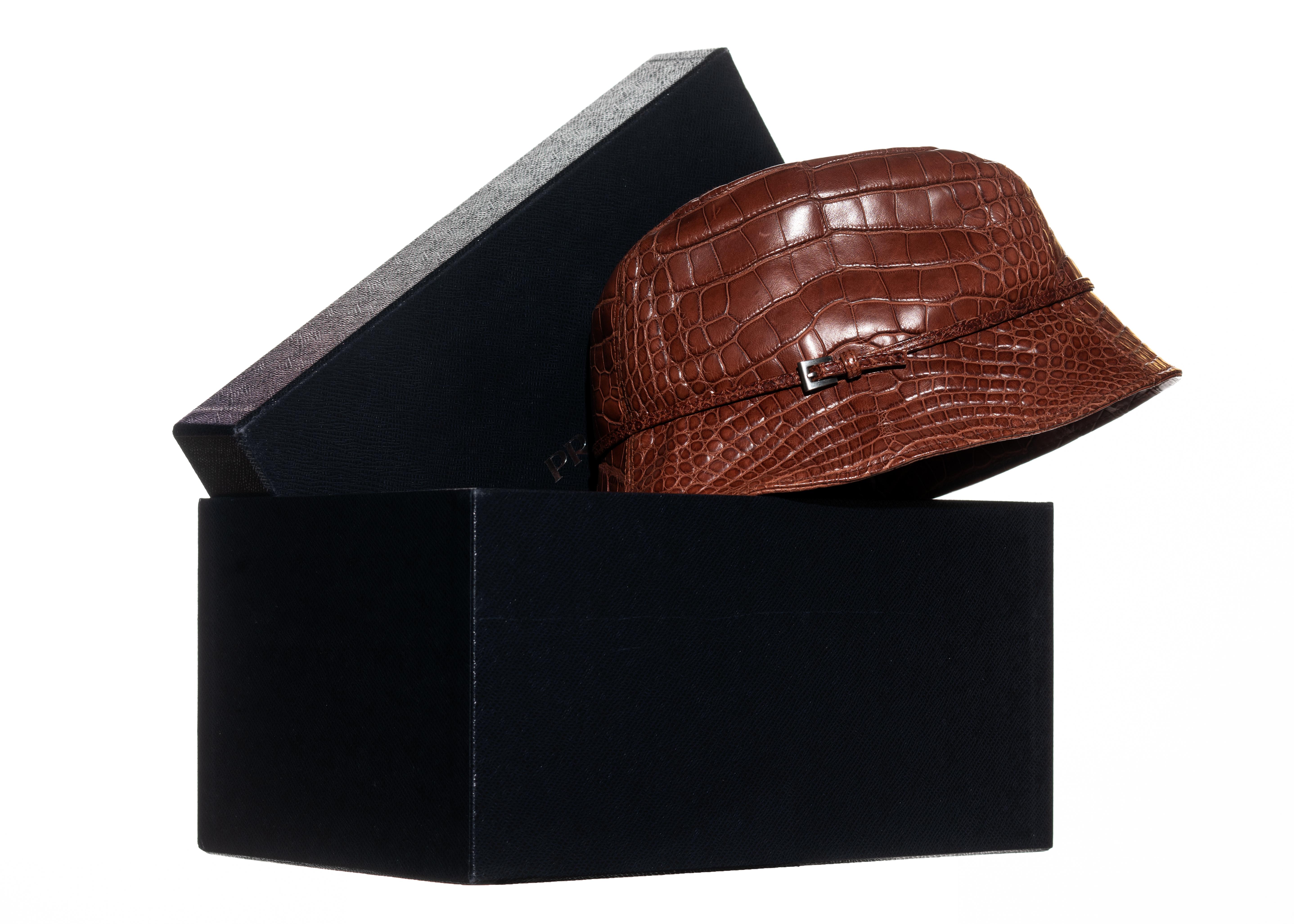 ▪ Prada brown alligator bucket hat
▪ Metal buckle detail 
▪ Limited edition
▪ Nylon lining 
▪ Comes with Prada hat box
▪ Size Medium
▪ Fall-Winter 2003