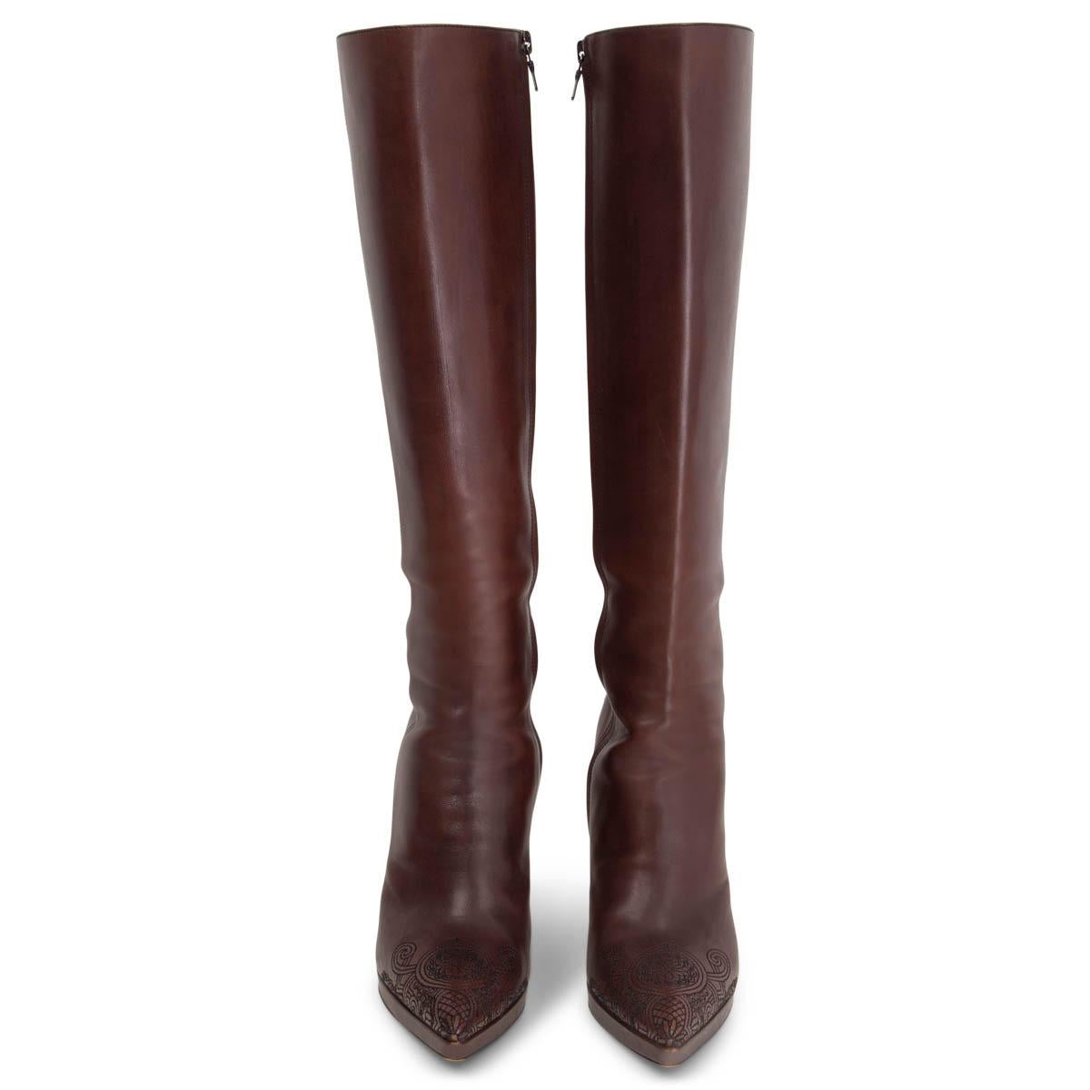 100% authentic Prada pointed-toe knee-high distressed boots in brown calfskin with embroidered tip and heel. Open with a zipper on the inside. Have been worn and are in excellent condition. 

Measurements
Imprinted Size	37.5
Shoe Size	37.5
Inside