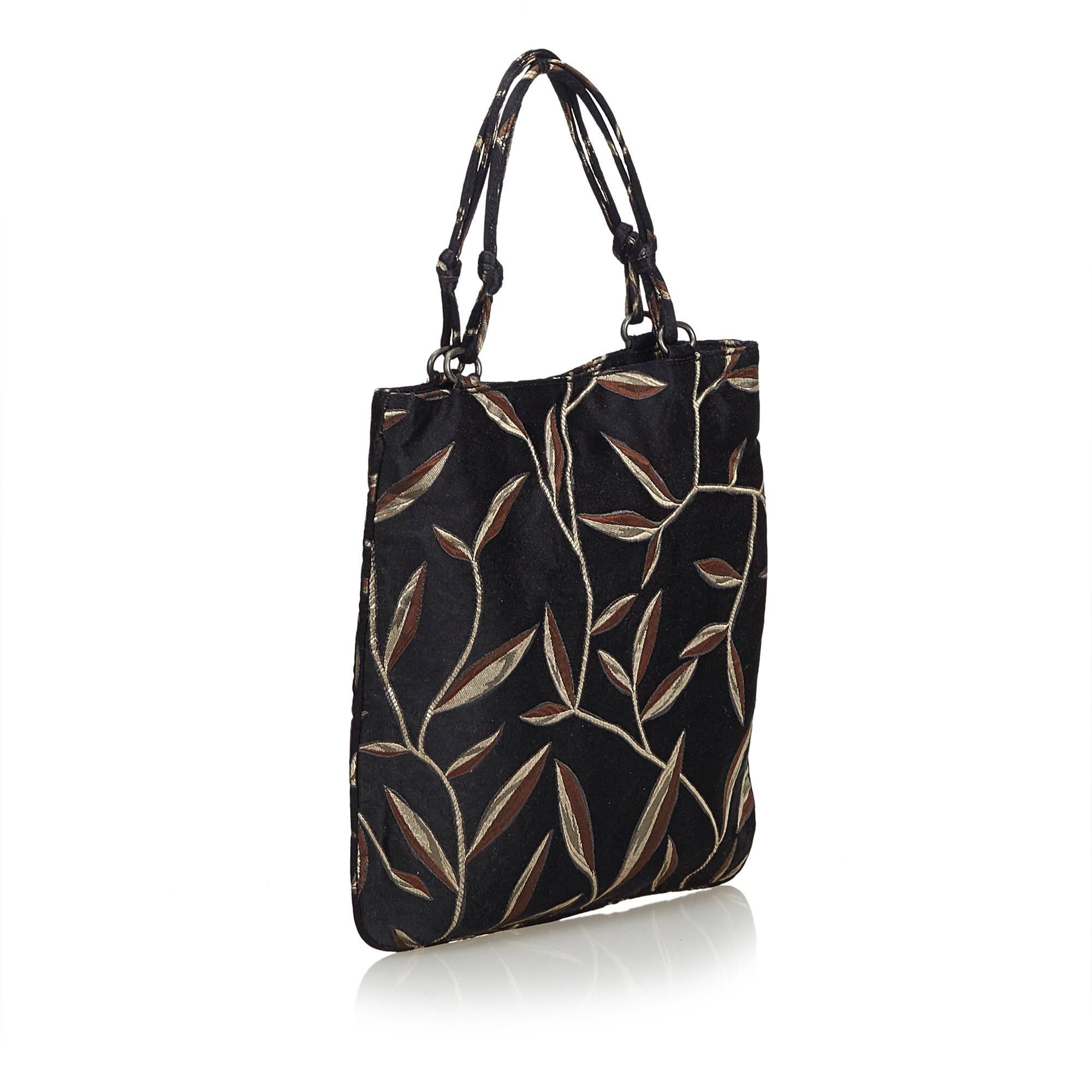 This tote bag features a fabric body, flat straps, and an open top with a push button closure. It carries as AB condition rating.

Inclusions: 
Dust Bag

Dimensions:
Length: 23.00 cm
Width: 23.00 cm
Depth: 1.00 cm
Hand Drop: 11.00 cm
Shoulder Drop: