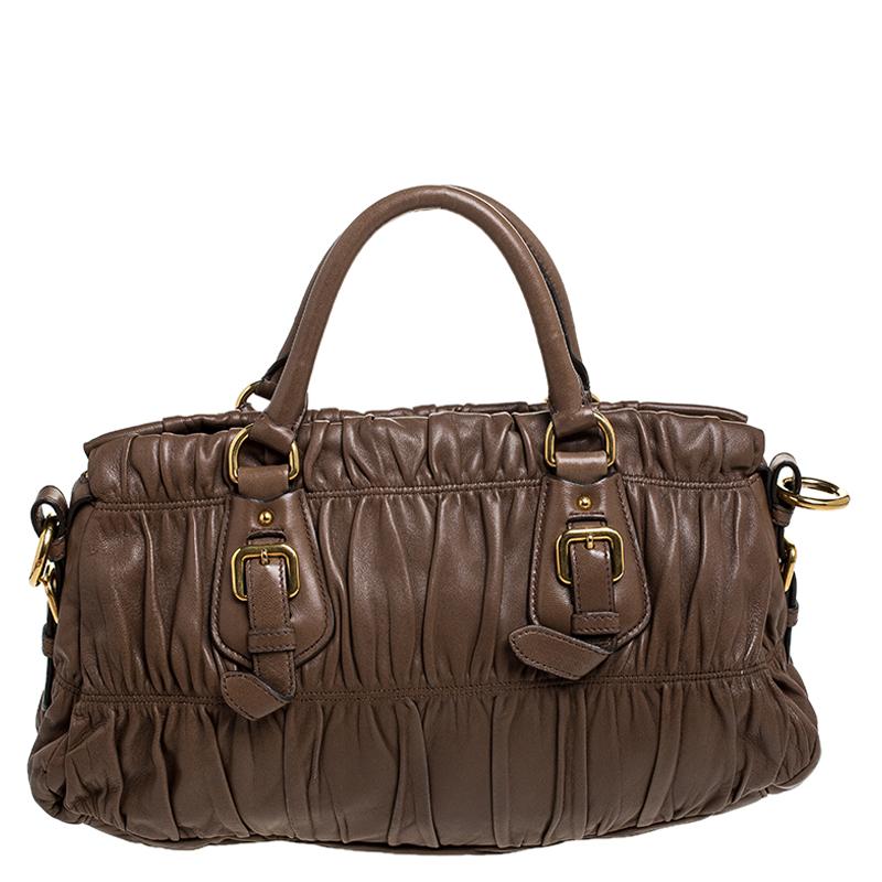Prada brings you this lovely satchel that has been crafted from gathered leather in a brown hue. It has a well-sized nylon interior and the bag is complete with two top handles. Stylish and ideal for daily use, this bag is a worthy buy.

Includes: