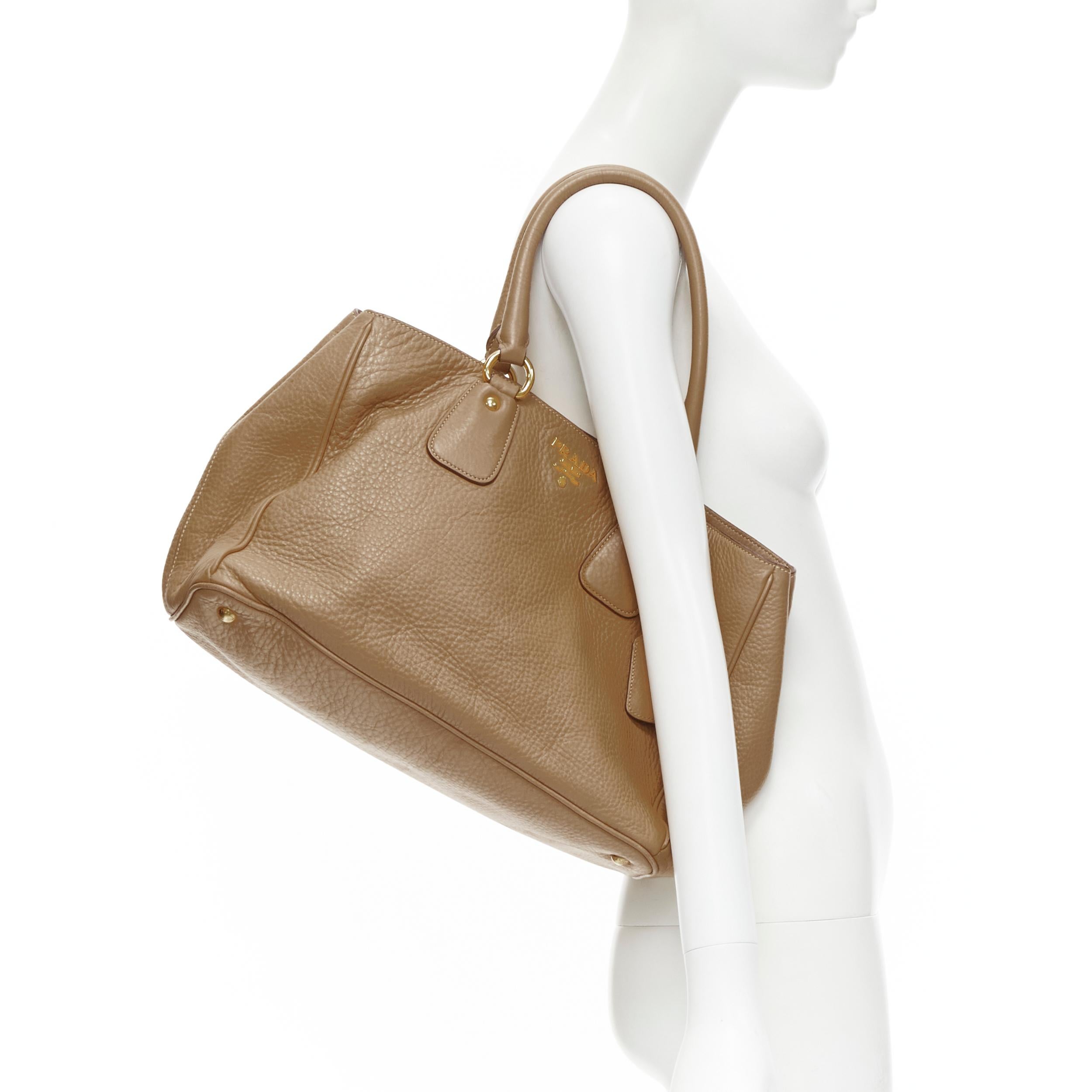 PRADA brown grained pebble leather gold logo applique tote bag 
Reference: TGAS/B01990 
Brand: Prada 
Designer: Miuccia Prada 
Material: Leather 
Color: Camel 
Pattern: Solid 
Closure: Button 
Extra Detail: Grained pebble leather. Gold-tone