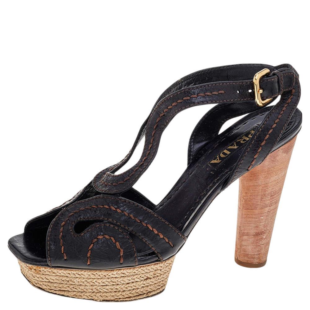 Add an element of glam and elegance to your ensemble as you wear these sandals from the House of Prada. They are created using brown leather on the exterior and come with espadrille platforms, wooden heels, and gold-toned implements. Amp up your
