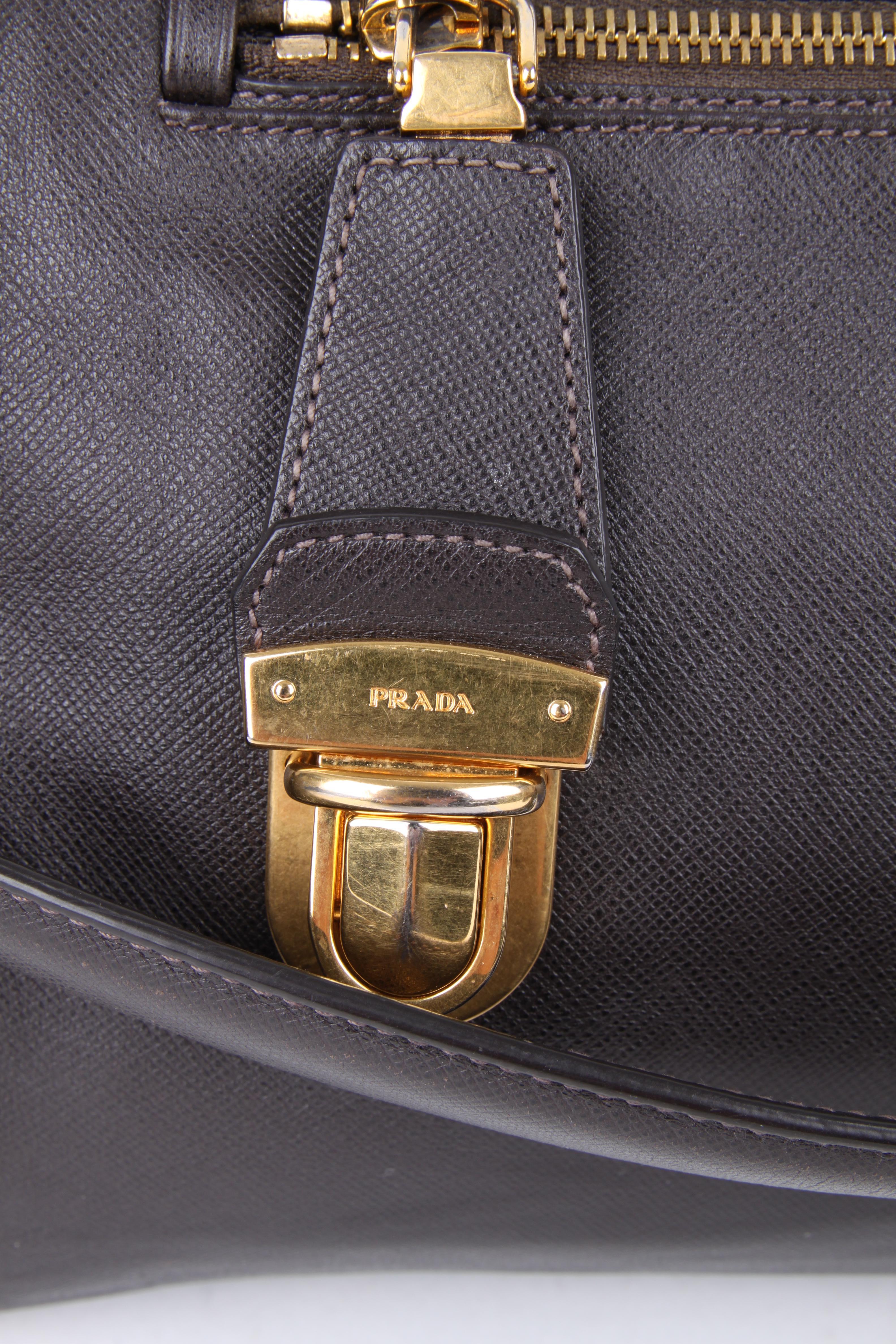 Prada Brown Leather Green Canvas Handbag.

This little bag makes a big statement. It features leather exterior with matching brown leather handles. The bag features a brown silk lining, zipper closure, one main compartment and two side compartments.